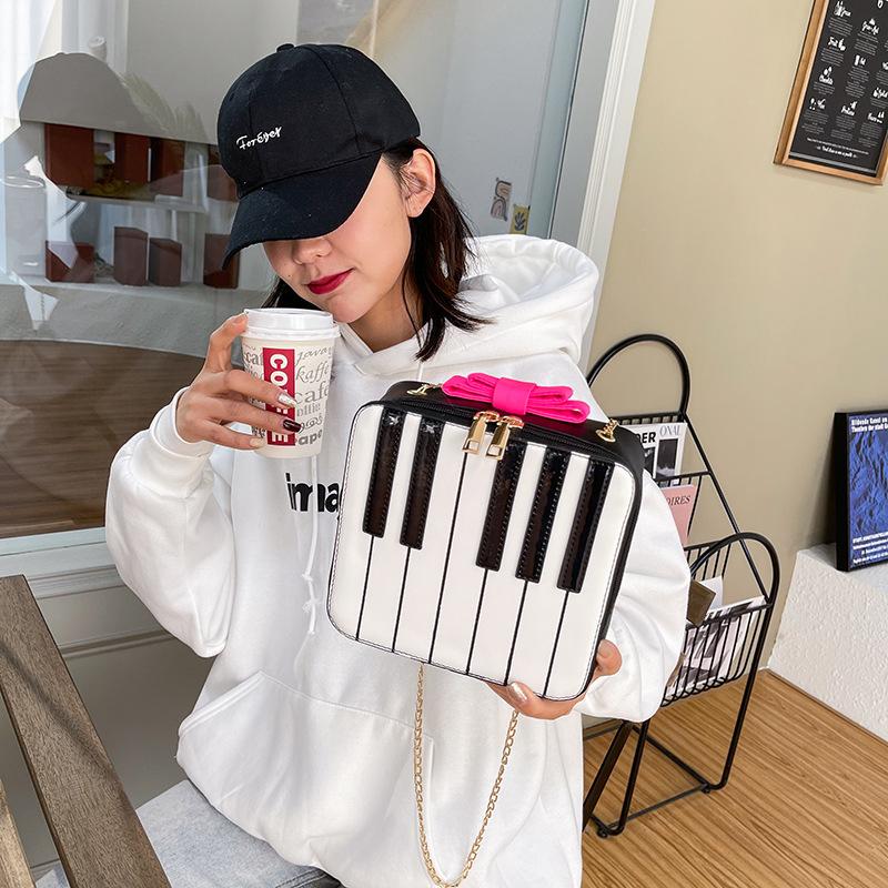 

Personalized piano small bag 2025 fashion bow small fresh literary girl versatile chain crossbody box bag рожевий