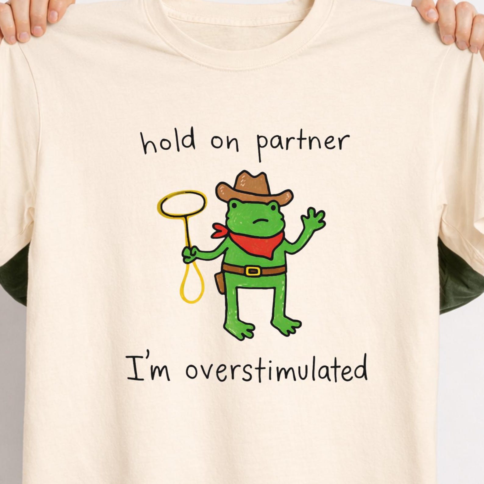 Stylish Cowboy Frog “Hold On Partner, I’m Overstimulated” Shirt – Cute Childlike Doodle Western Frog Tee. M