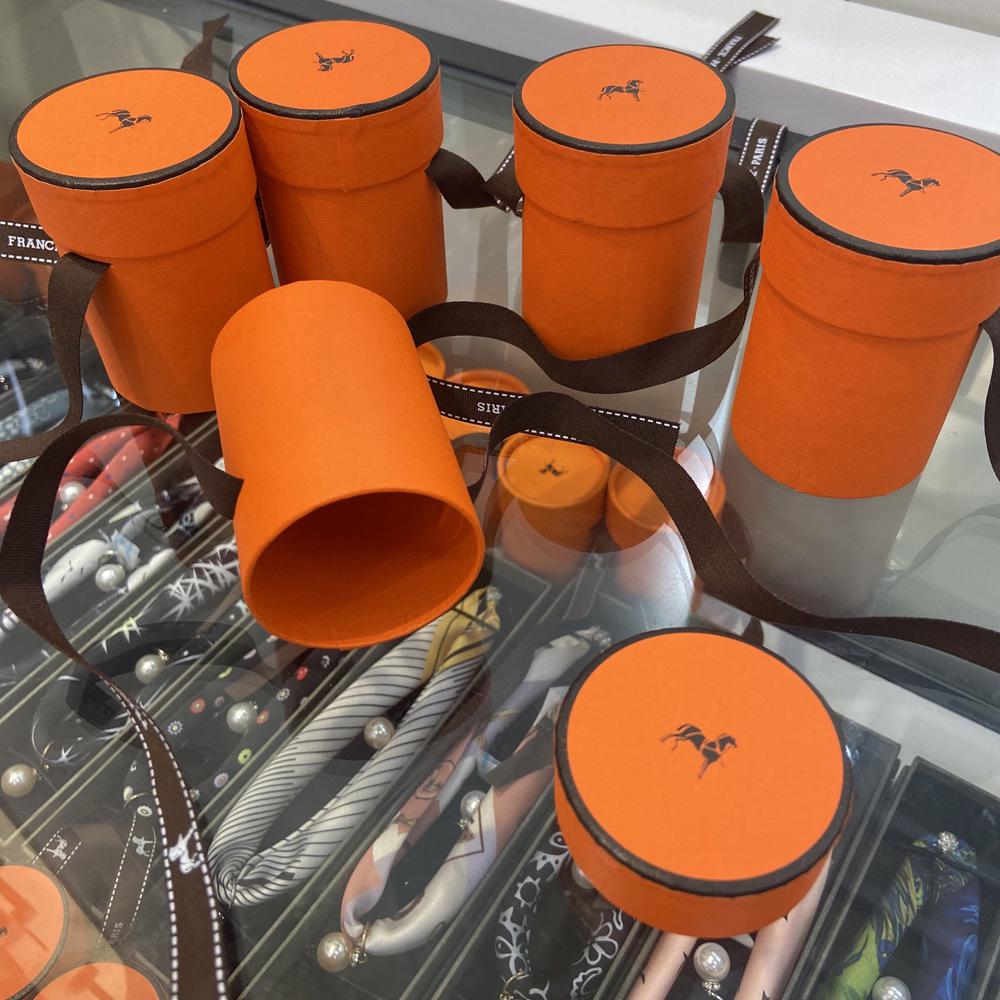 Exquisitely Decorated Orange Round Gift Box with Ribbon Neckerchief