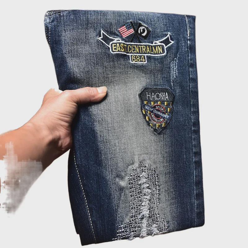 Men's Slim-Fit Embroidered Floral Distressed Jeans with Patches and Elastic Trim.