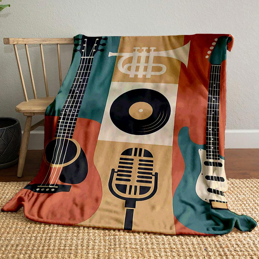 The pattern features guitars, a trumpet, a microphone, and a vinyl record. for all seasons blanket lunch break throw gift