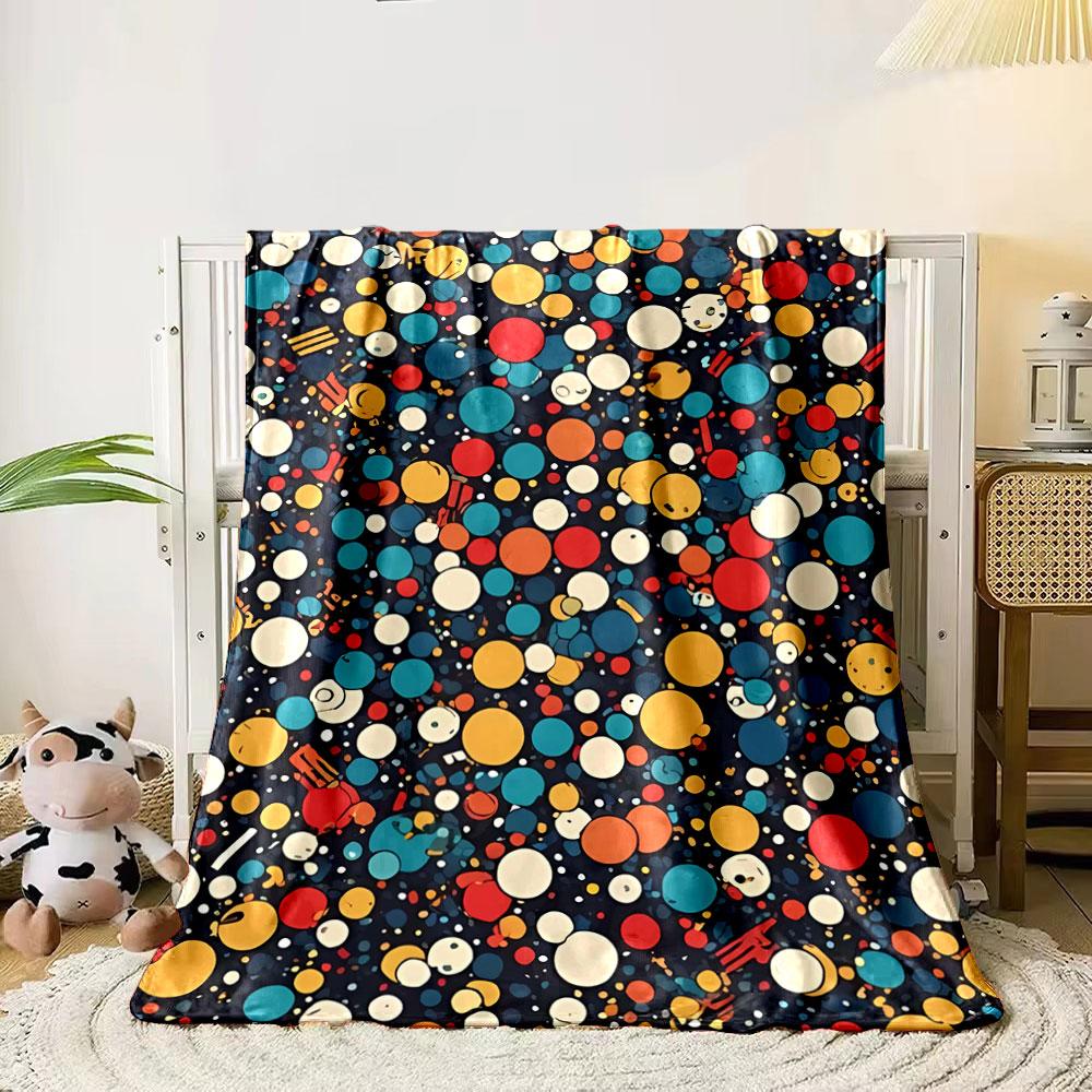 A colorful pattern of varying-sized circles with smiling faces on dark. for all seasons blanket lunch break throw gift