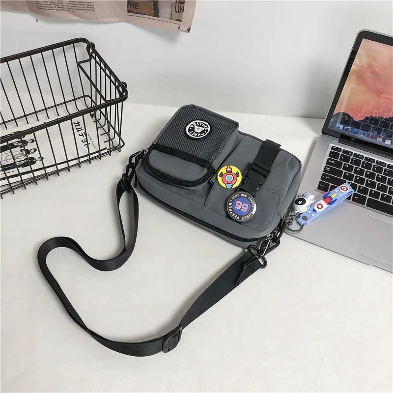 Unisex Plain Color Crossbody Bag, Casual Zipper Shoulder Bag with Astronaut Charm & Random Badge, Versatile Daily Messenger Bag