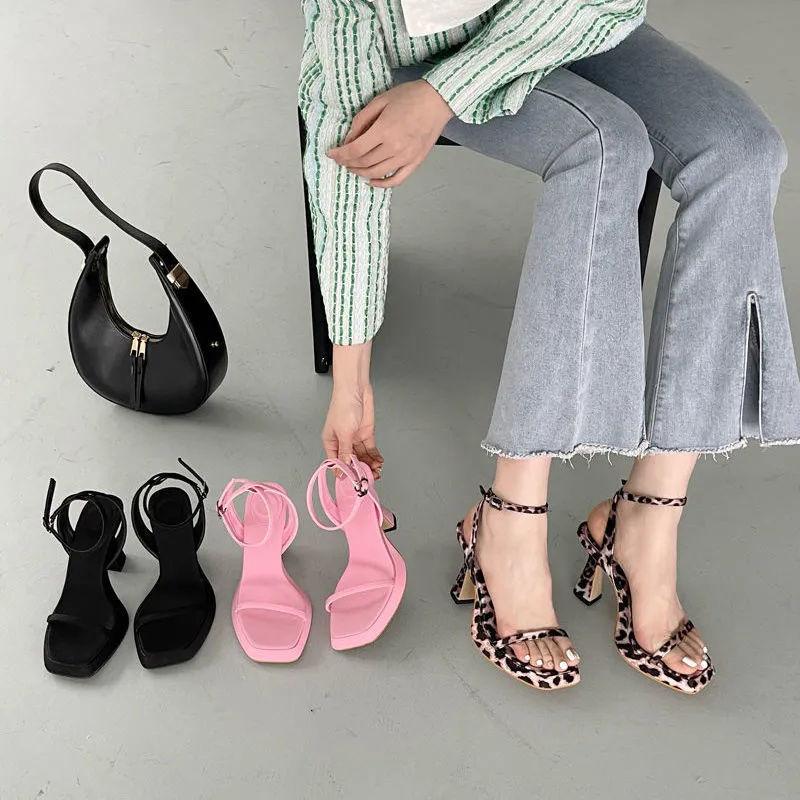 Spring and summer one-word buckle high heels design sense niche pink sexy waterproof table square head sandals women