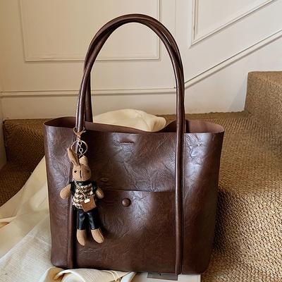 Un sac seau à main tendance et élégant, un sac à bandoulière simple rétro