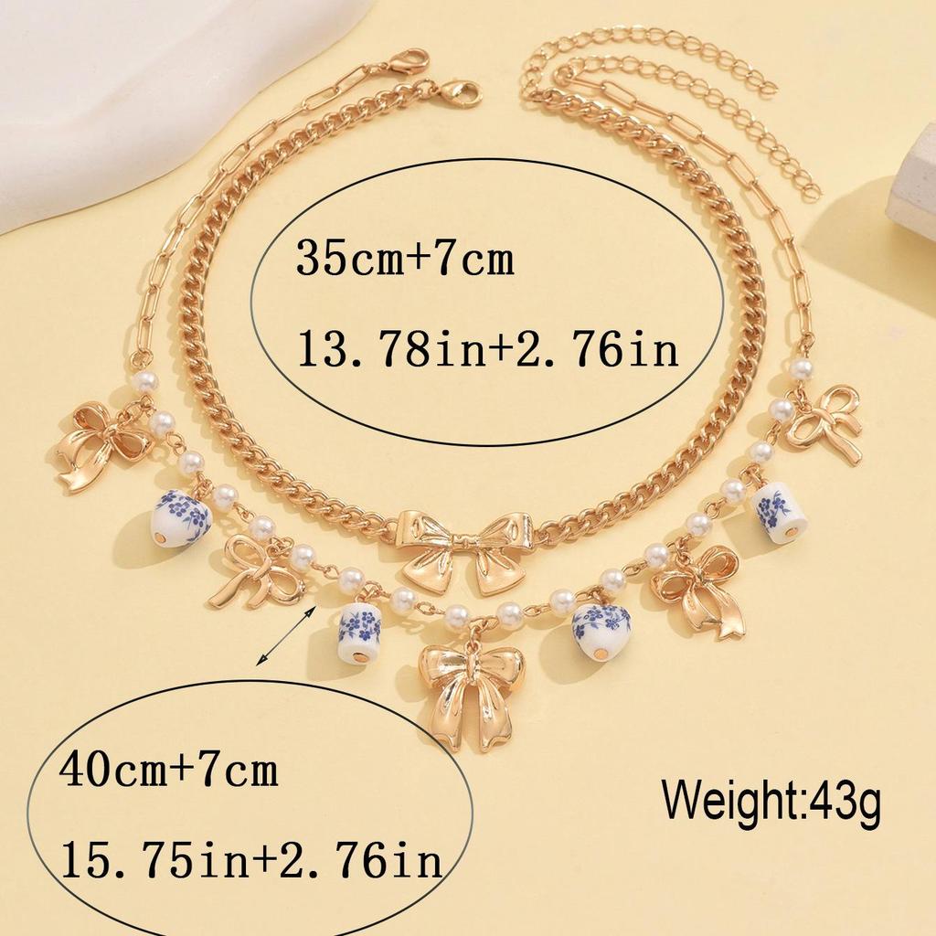 Doppellagige Perlen-Schleifen-Anhänger-Halskette - Modische Keramik-Schlüsselbeinkette