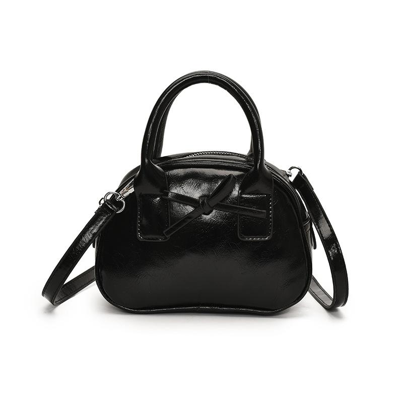 Südkoreas beliebte Nische einfache einfarbige tragbare Bowlingtasche Damen lässig ausländischer Stil hochwertige vielseitige Umhängetasche