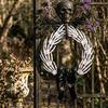 White Bone Garland Halloween Skeleton Hand Wreath for Front Door, Gothic Spooky Hanging Decoration Rattan with Black Bow And Skulls Door Wall Holiday
