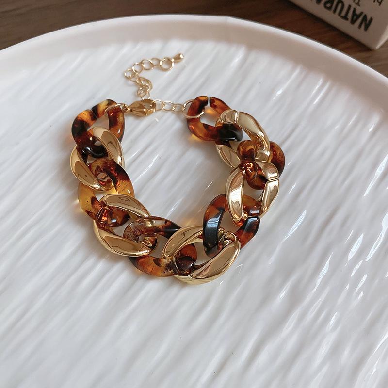 Meillard Leopard Print Jewelry Set: Interlocking Earrings, Necklace, Bracelet, and Ear Studs.