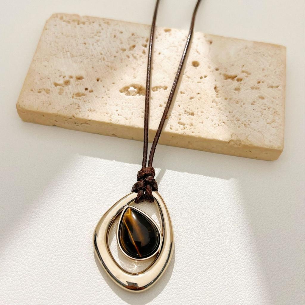 Irregular teardrop tiger's eye pendant necklace, vintage and unique.