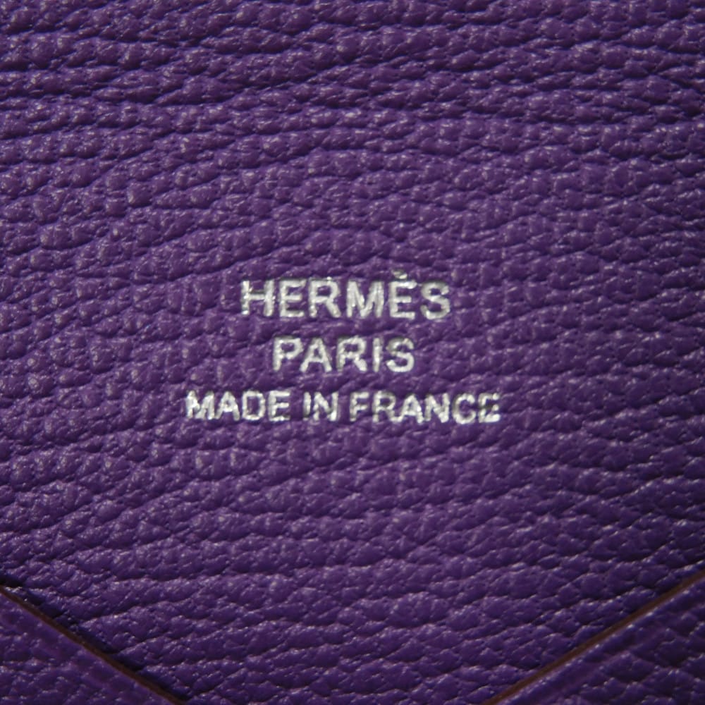 Used 9212 Calvi 7946 Chevre Mysore Goatskin Bag with Gold-stamped Logo and Purple Snap Buttons. Excellent Condition.