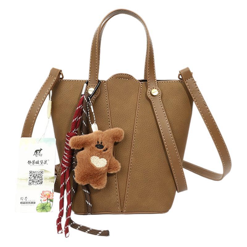 Hand carrying bucket bag at work 2025 new Korean texture versatile portable women's bag commuter messenger shoulder bag