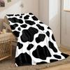 Black irregular spots on a white background resembling a cow print. for all seasons blanket lunch break throw gift