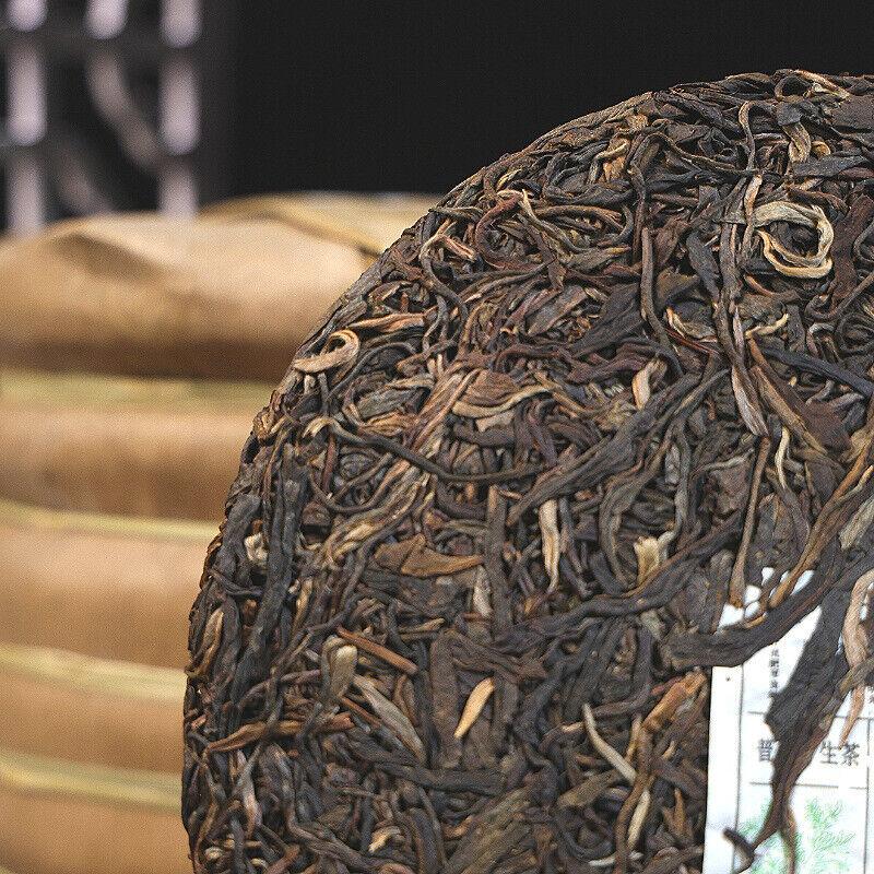 Yiwu Zhengshan Tee Blumenduft Pu'er Teekuchen Siebensamenkuchen Tee 357g