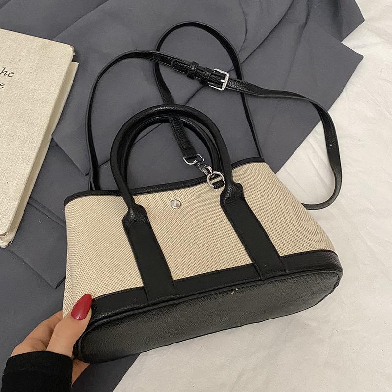 Spring new fashion contrasting color splicing portable bucket bag women's leisure work commuter wind messenger letter bag