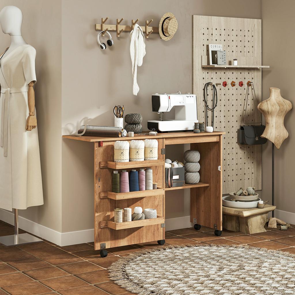 Folding sewing table, sewing furniture with drop-down leaf, storage bins, open shelf and casters, brown