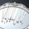 Set di 9 Collane con Ciondoli Eleganti in Zircone da Donna Moda Colore Rosa Croce Farfalla Cuore Fiocco Collane Gioielli da Festa Regalo