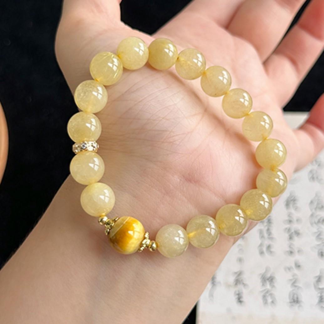 

Женский браслет из золотистого кварца-рутила и тигрового глаза - Желтые кристальные бусины