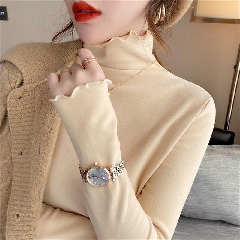 

Європейська футболка жіноча приталена з довгим рукавом однотонна з коміром-стійкою та рюшами по краю M абрикосовий