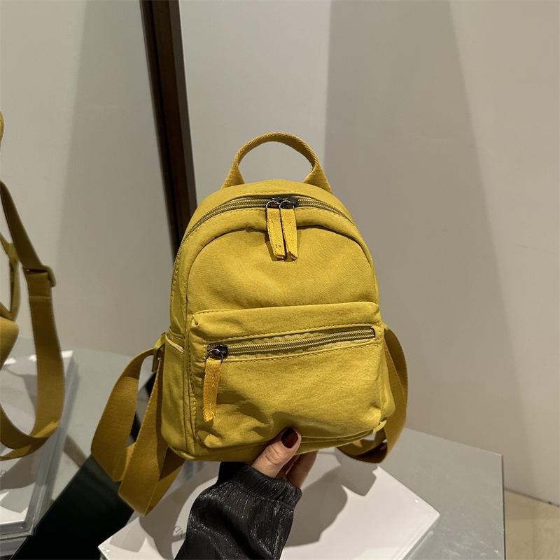 Einfacher lässiger Mini-Rucksack für Damen 2025 neue modische einfarbige kleine Tasche klein frisch Studenten-Reiserucksack