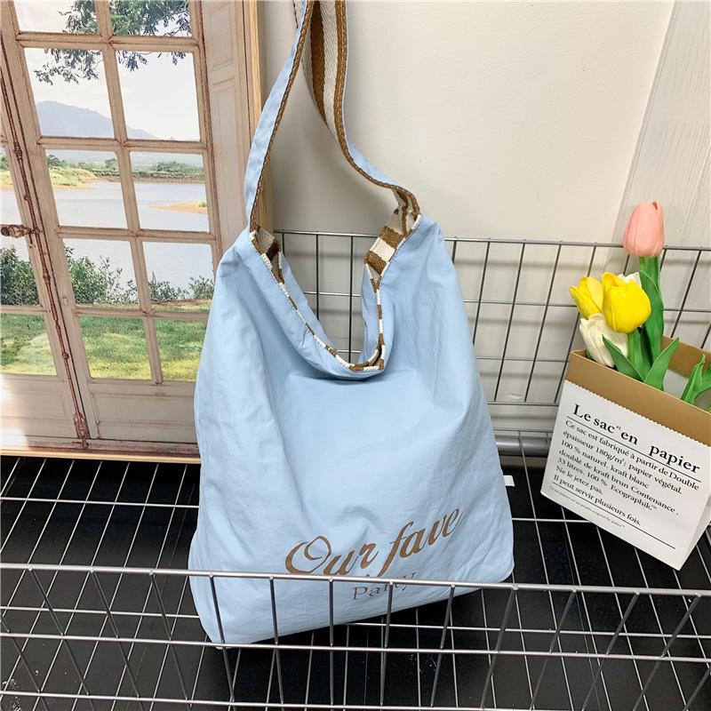 

Casual large-capacity striped canvas bag women s 2025 new commuter shoulder bag lightweight versatile tote bucket bag 27*12*33