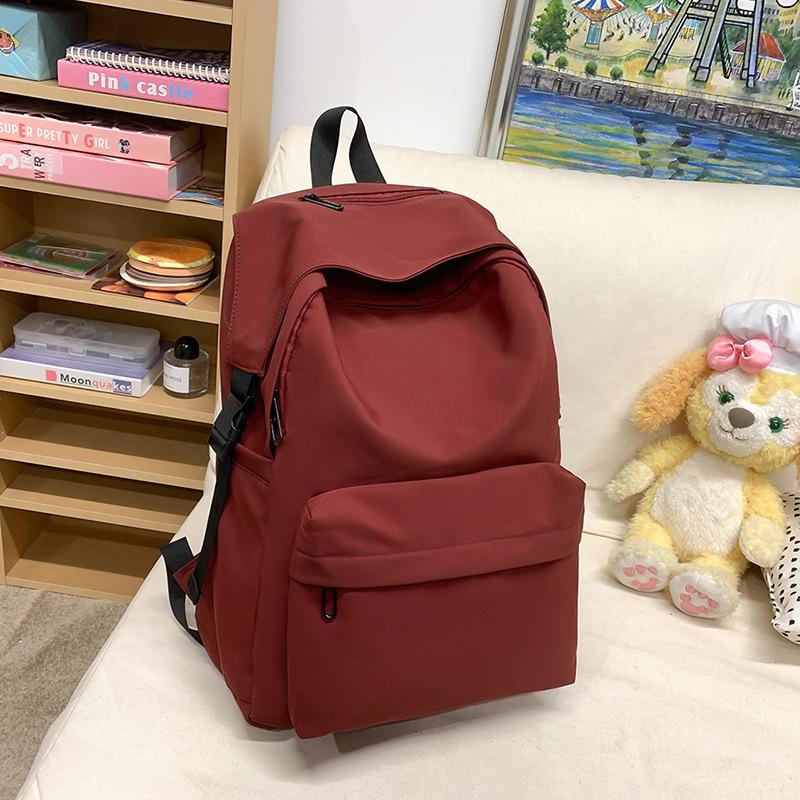 2025 new large-capacity simple backpack large-capacity men s and women s same high school students versatile solid color schoolbag красный
