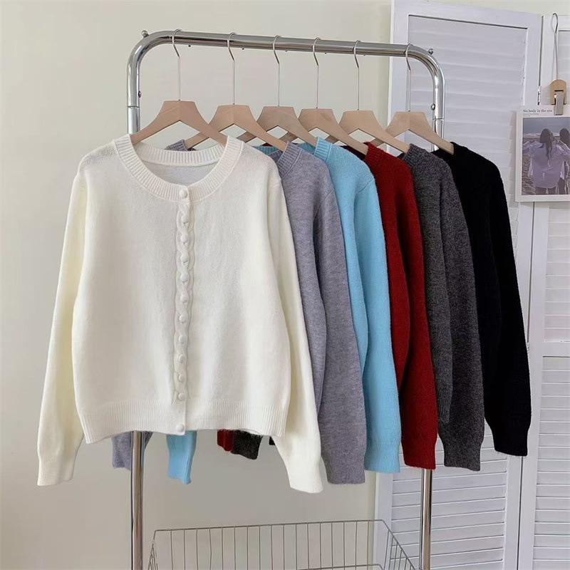 Autumn new solid color round neck single-breasted splicing long-sleeved knitted sweater women's fashion age-reducing top