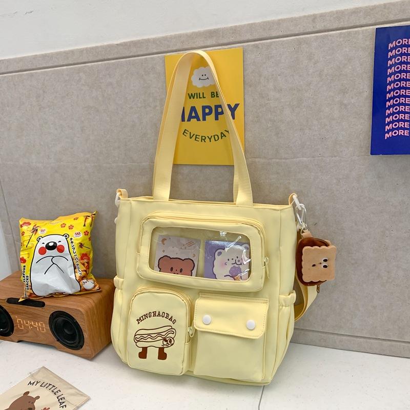 

Нишевый дизайн Высокая ценность Японская милая сумка-тоут для репетиторства Большая вместимость Студенческая сумка для класса Сумка через плечо