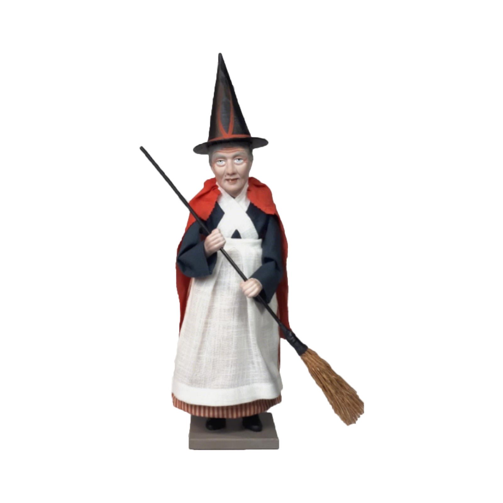 

Ретро ведьма, держащая фигурку в форме метлы One Size