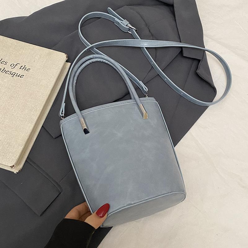 

Весна и лето горячая распродажа простая конфетного цвета портативная сумка-ведро женская корейский темперамент стиль для поездок на работу универсальная текстурная сумка-мессенджер