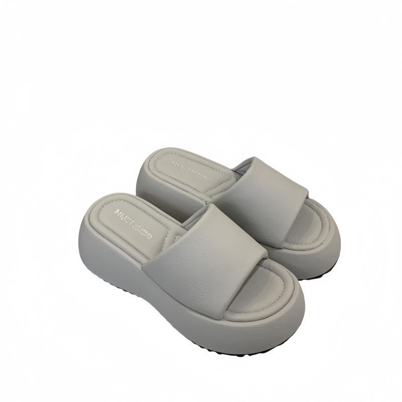 In the summer of 2025, the new thick-soled one-word cool slippers wear candy color with skirts to increase the height of beach shoes for women