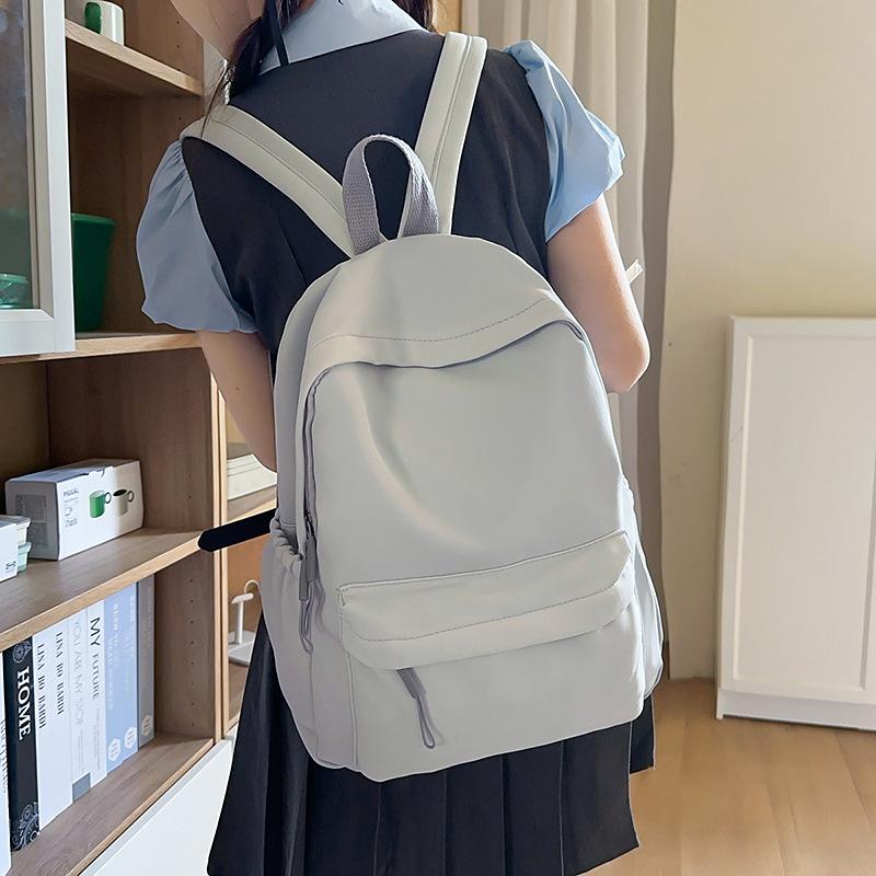 Solid color simple backpack girls' junior high school college student schoolbag large capacity niche versatile design large capacity backpack