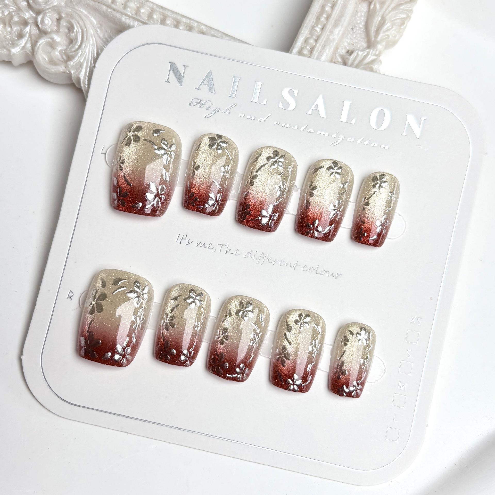 

Brownish-Red Gradient Cat Eye Press-On Nails with Gold Glitter and Floral Design