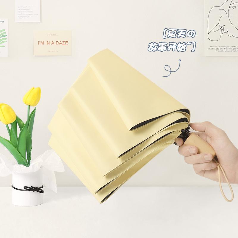New three-fold simple plain color windproof and sun protection creative solid wood handle female vinyl parasol