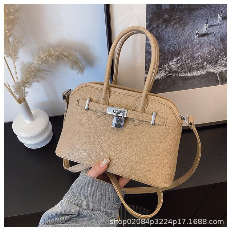 2025 new women's lychee pattern solid color lock shoulder bag temperament niche versatile commuter portable messenger