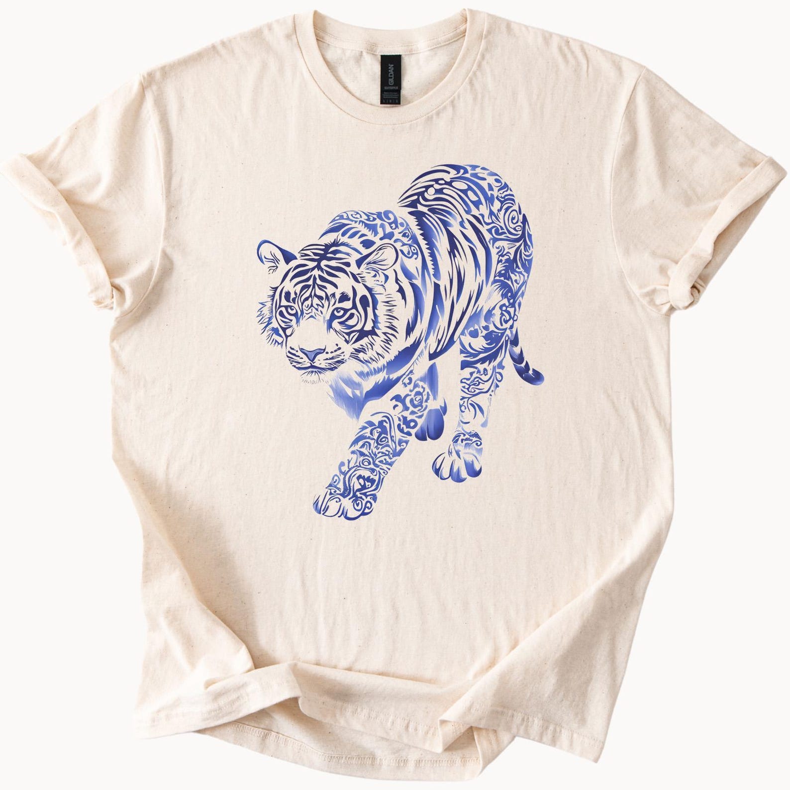 Blue tribal tattoo style tiger graphic walking forward detailed big cat art on soft natural beige shirt animal wildlife design tee 150
