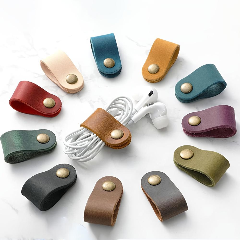 

6pcs PU leather cable and earphone cord straps, no batteries, available in various colors, durable and flexible.