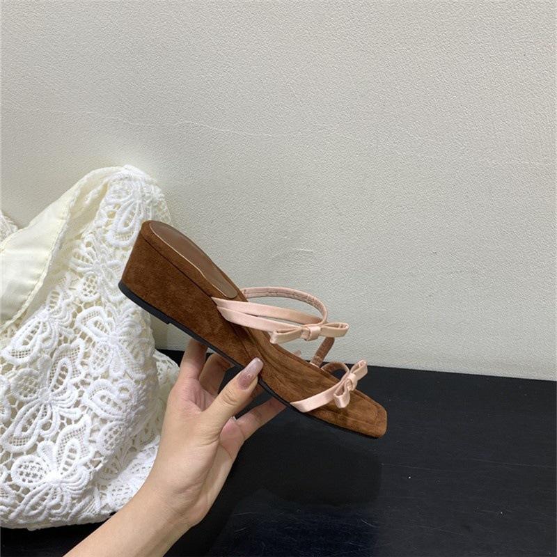 

French beautiful bow thick-soled cool slippers women s fashion 2025 summer with skirt one-word wedge slippers 35