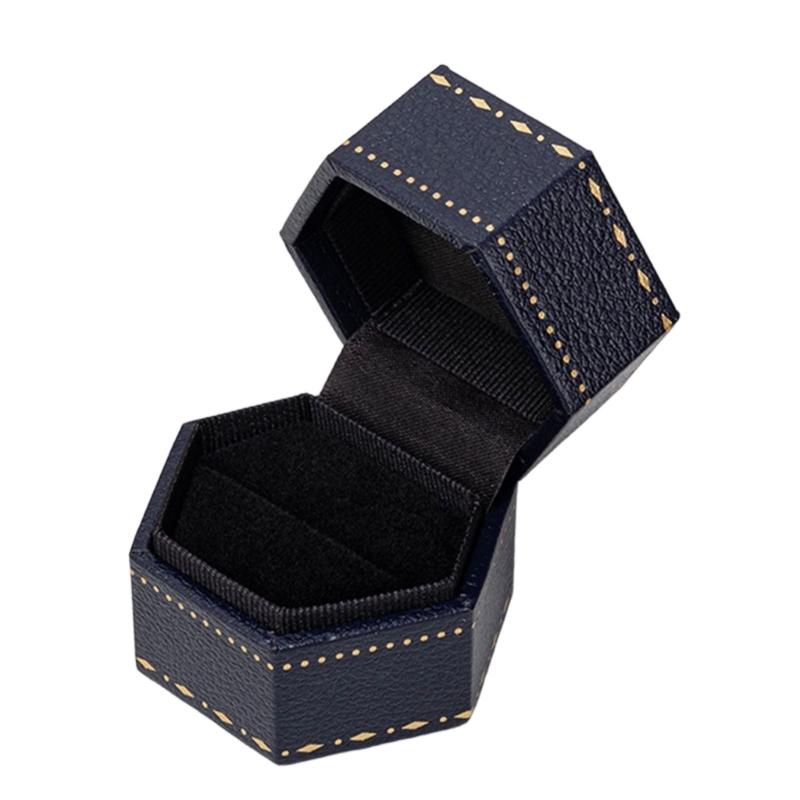 Hexagonal Ring Presentation Box with Black Interior, Gold-Tone Border Pattern, and Attached Lid for Retail Display
