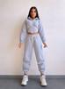 European and American fashion casual women's solid color long-sleeved waist cardigan hooded sweater strappy pants two-piece set
