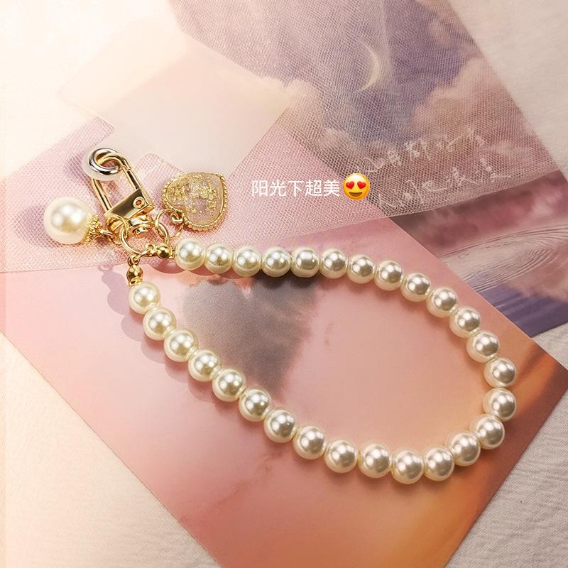 Mobile phone lanyard, portable Chinese style retro pearl bracelet, short wrist rope, handmade beaded round bead keychain hanging.