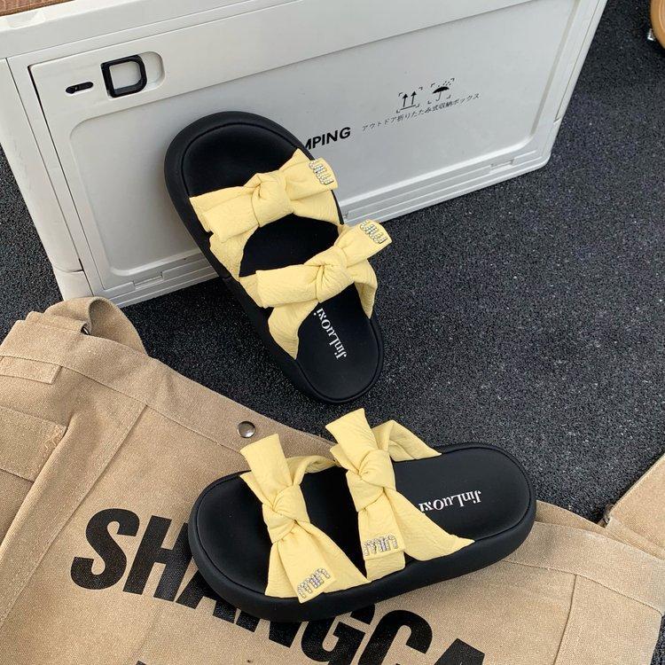 

Yellow slippers women wear one-word bow flat bottom summer 2025 new with skirt beach cool slippers 35