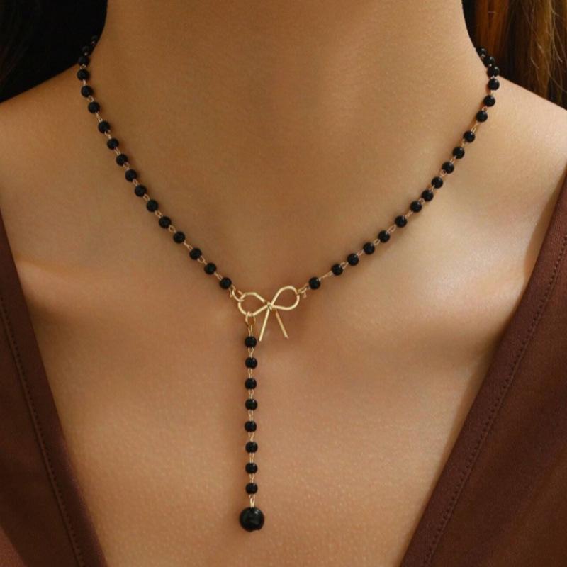Elegant Pearl Bowknot Tassel Pendant Necklace: High-End Autumn Winter Women's Fashion