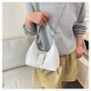 Solid color crescent-shaped hobo bag with metal D-ring embellishment, elegant underarm bag, versatile women's handbag for dates and everyday wear.