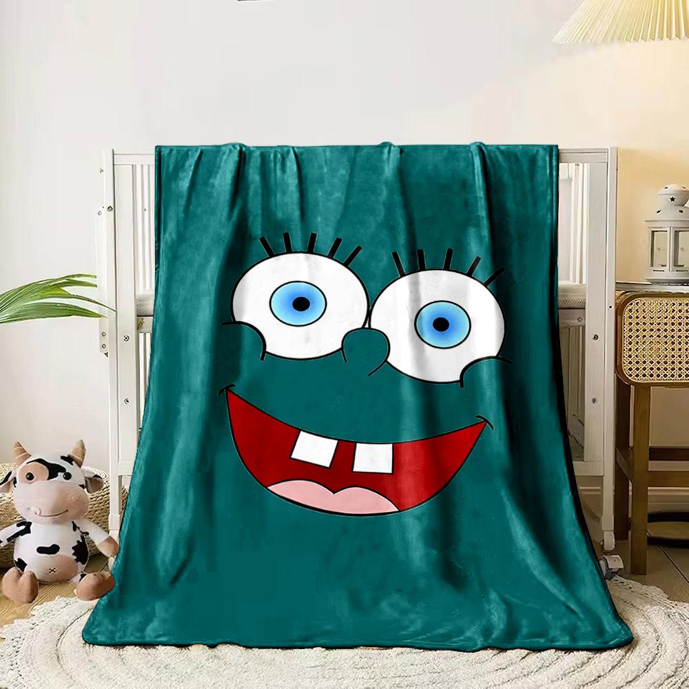 Bright cartoon face with large blue eyes, wide smile, and prominent teeth. for all seasons blanket lunch break throw gift