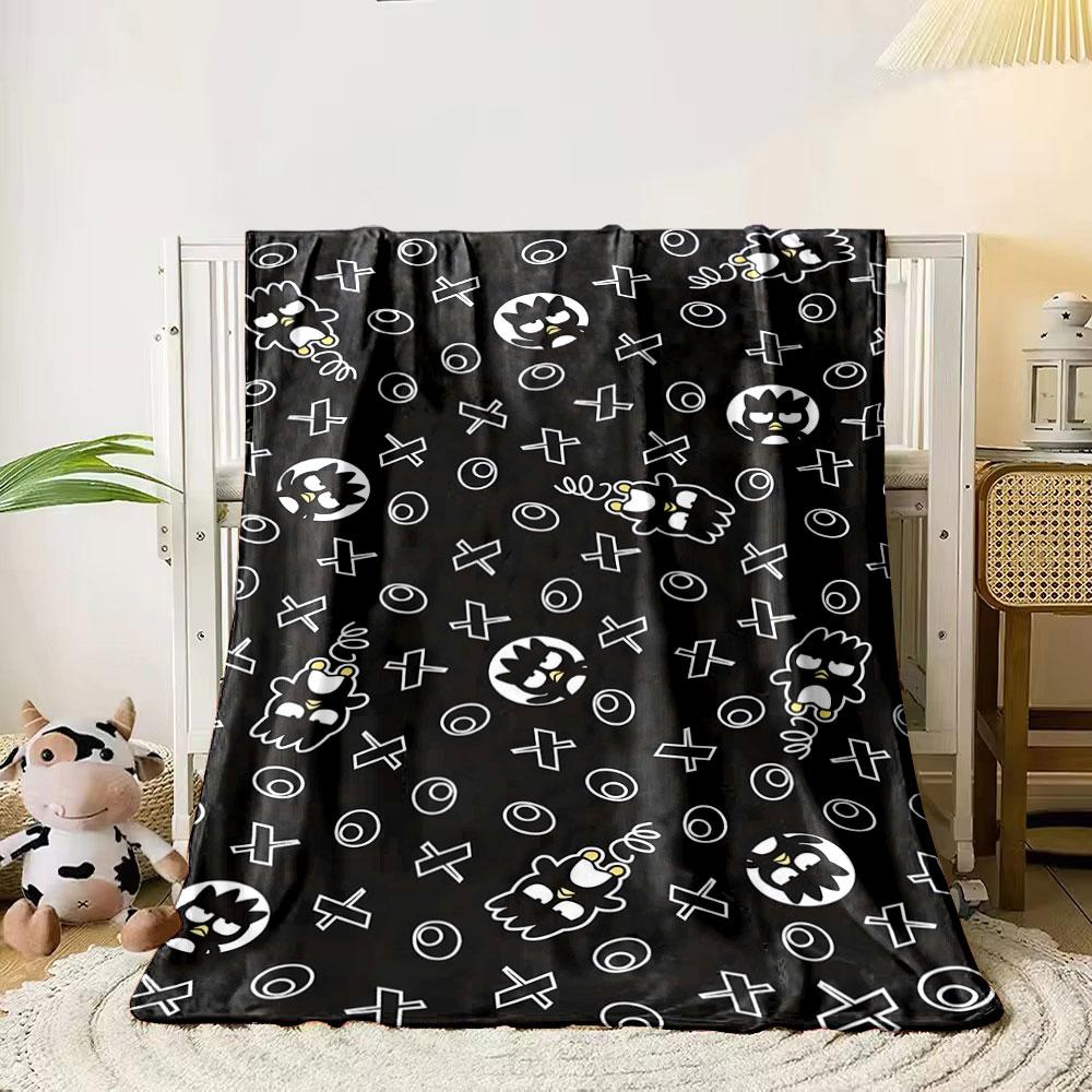 

Repeating cartoon faces, spirals, and white X and O shapes on black. for all seasons blanket lunch break throw gift 80cm x 120cm