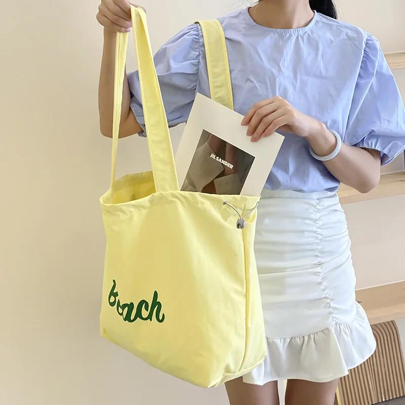 Einfarbige Damen Strand-Schultertasche mit Buchstaben-Design, Damen-Tote aus Canvas, Große Kapazität, Kordelzug, Damen-Einkaufstasche