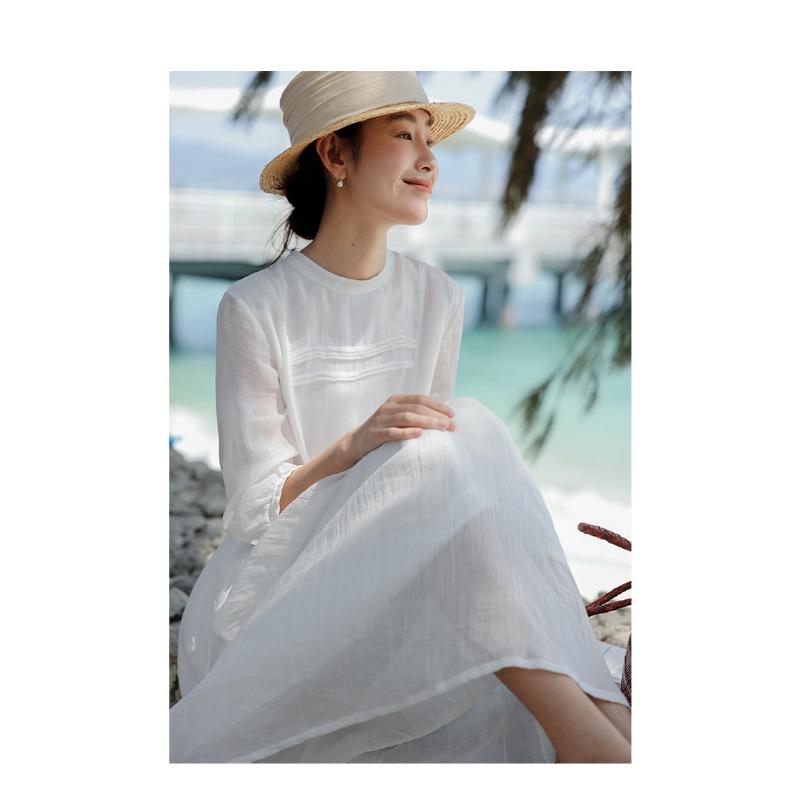 A Woman In A Double Layered Mid Length White Dress