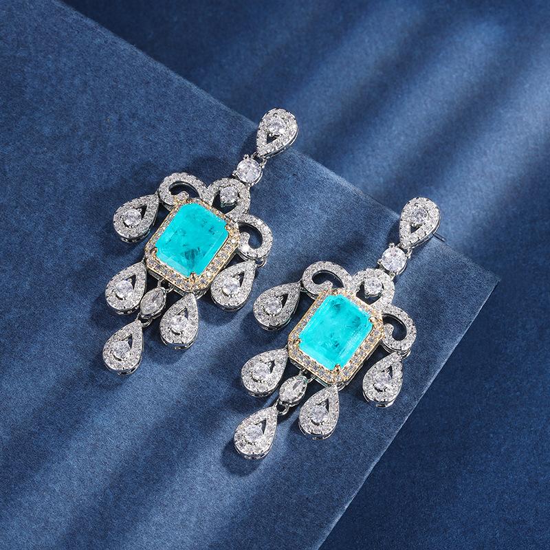 

Ювелирные изделия Медное основание с золотым покрытием Имитация изумруда Любовь Креативная бахрома Набор бриллиантов Главный камень 10 * 12 8 * 10