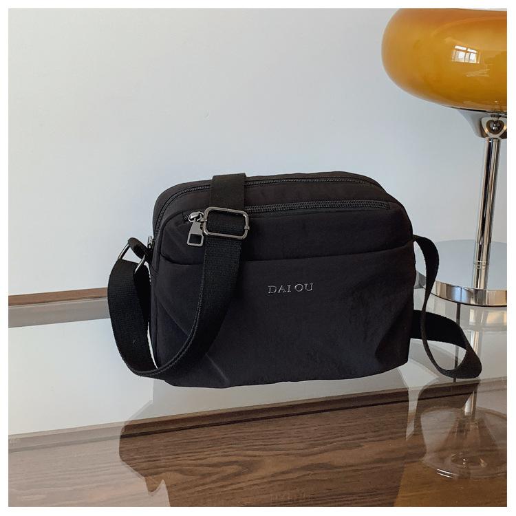 

2025 summer new messenger bag casual simple and lightweight nylon letter shoulder bag women s fashion versatile commuter bag чёрный